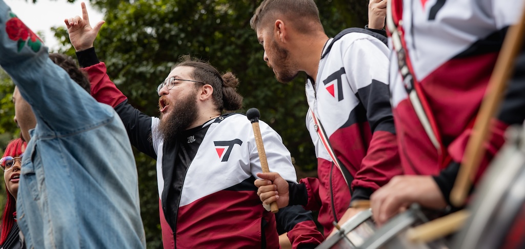 Torcida organizada da Pain Gaming gritando com tambores na entrada da Arena, saudando o time